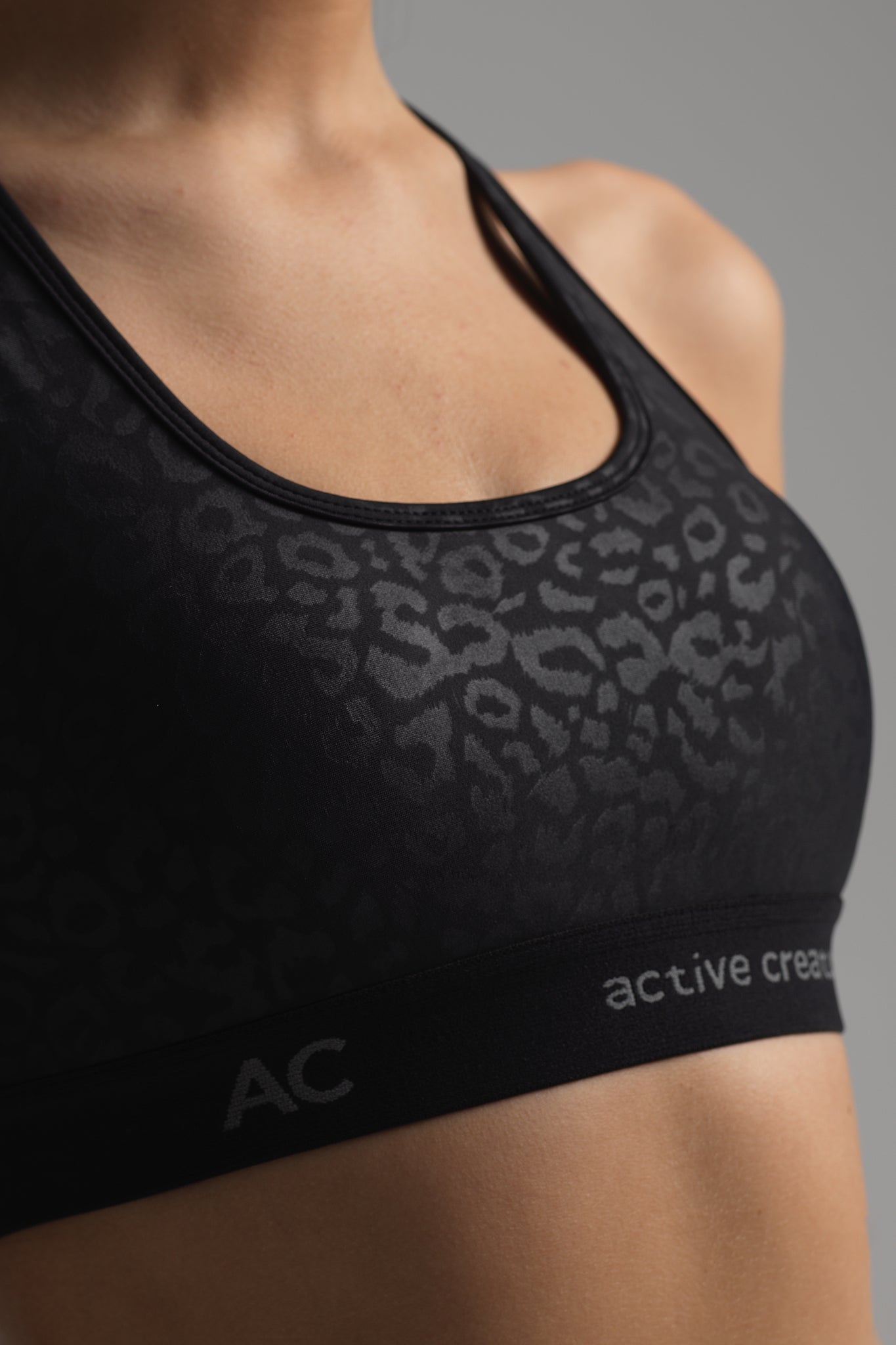 Luster Sports Bra in subtle black animal print (front view)