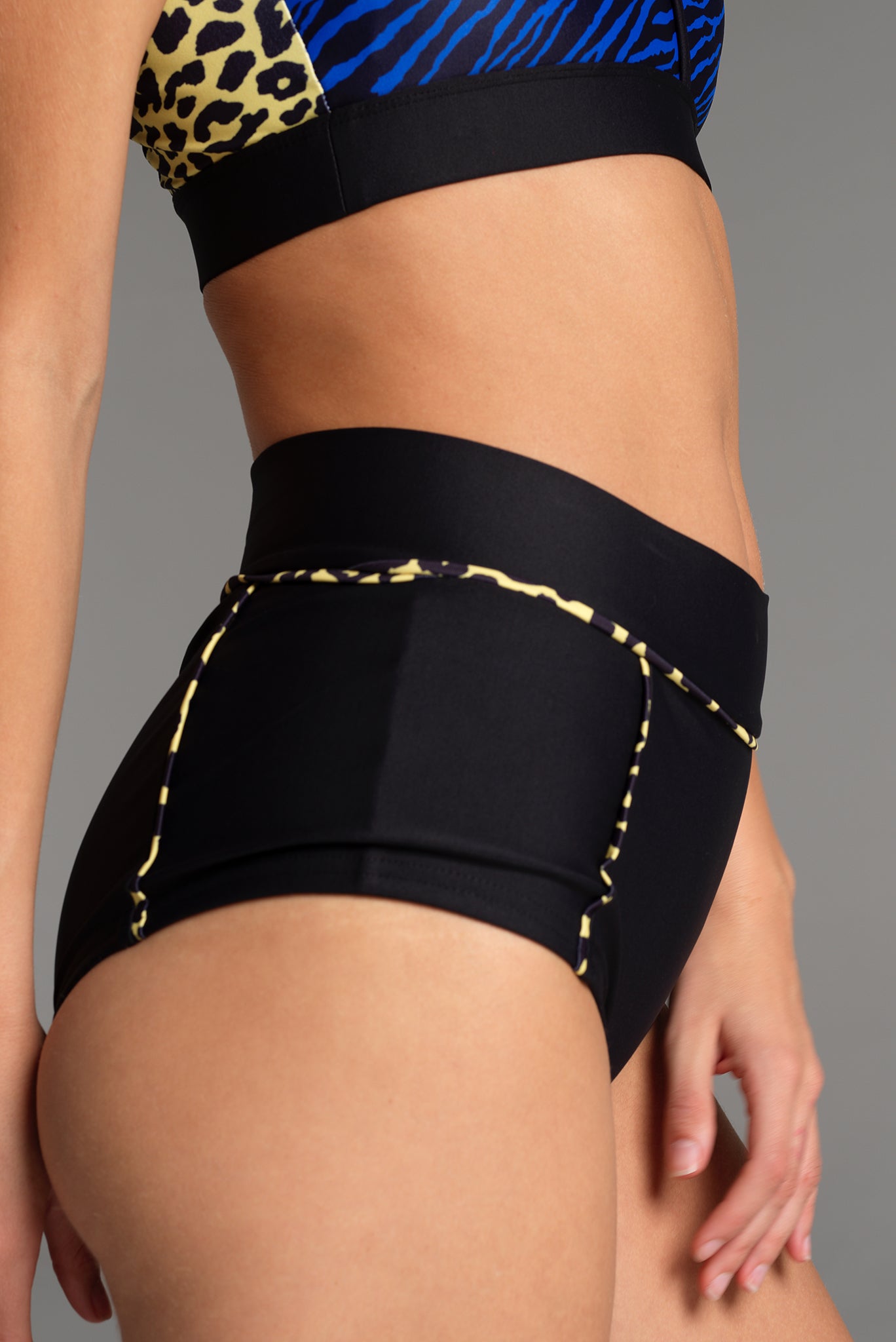 Side image of the X Trainer Sports Short, showing the panel design that lifts the leg line to create an elongated leg length.