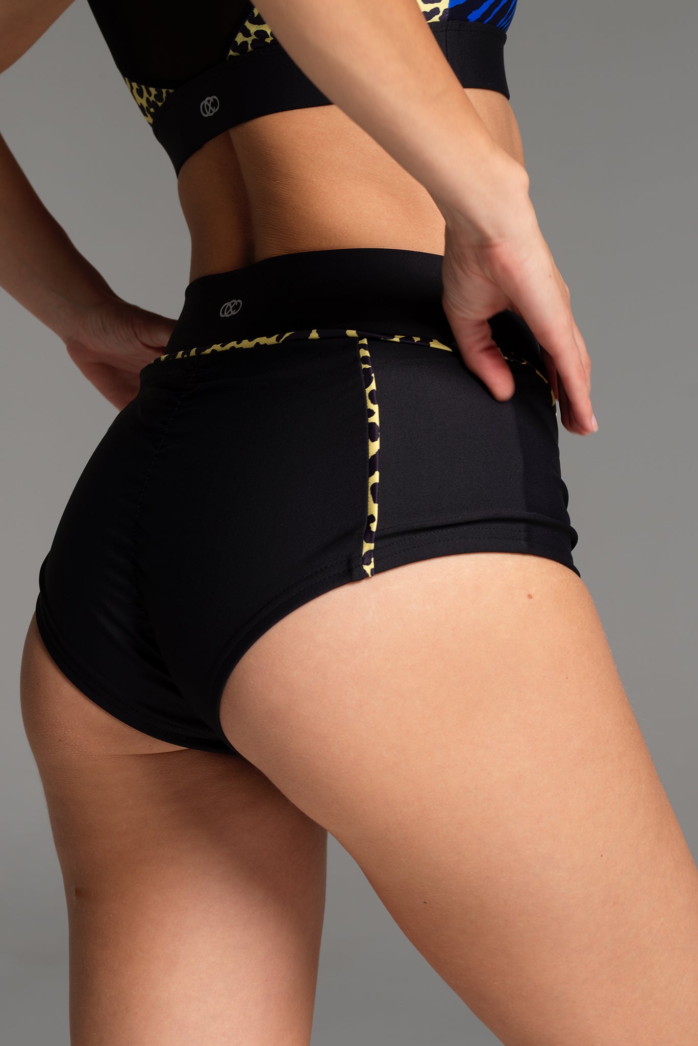 Rear view of the X Trainer Sports Short. The leg line is accentuated by the high waist design, while coverage across the bum remains.