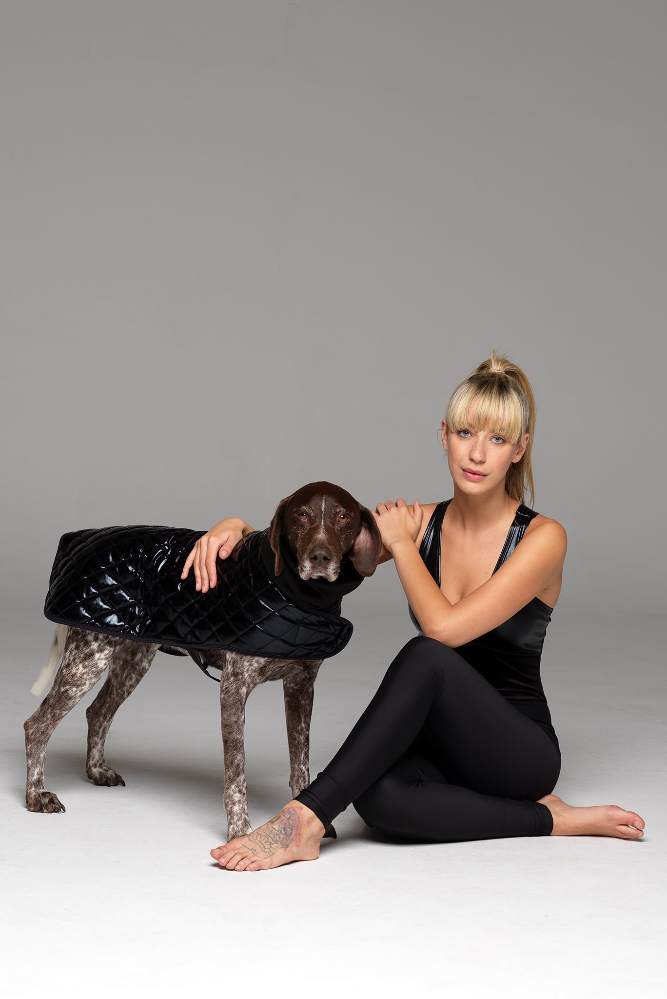 Dog in Alpha coat and Model in matching full piece "Night Call" catsuit.
